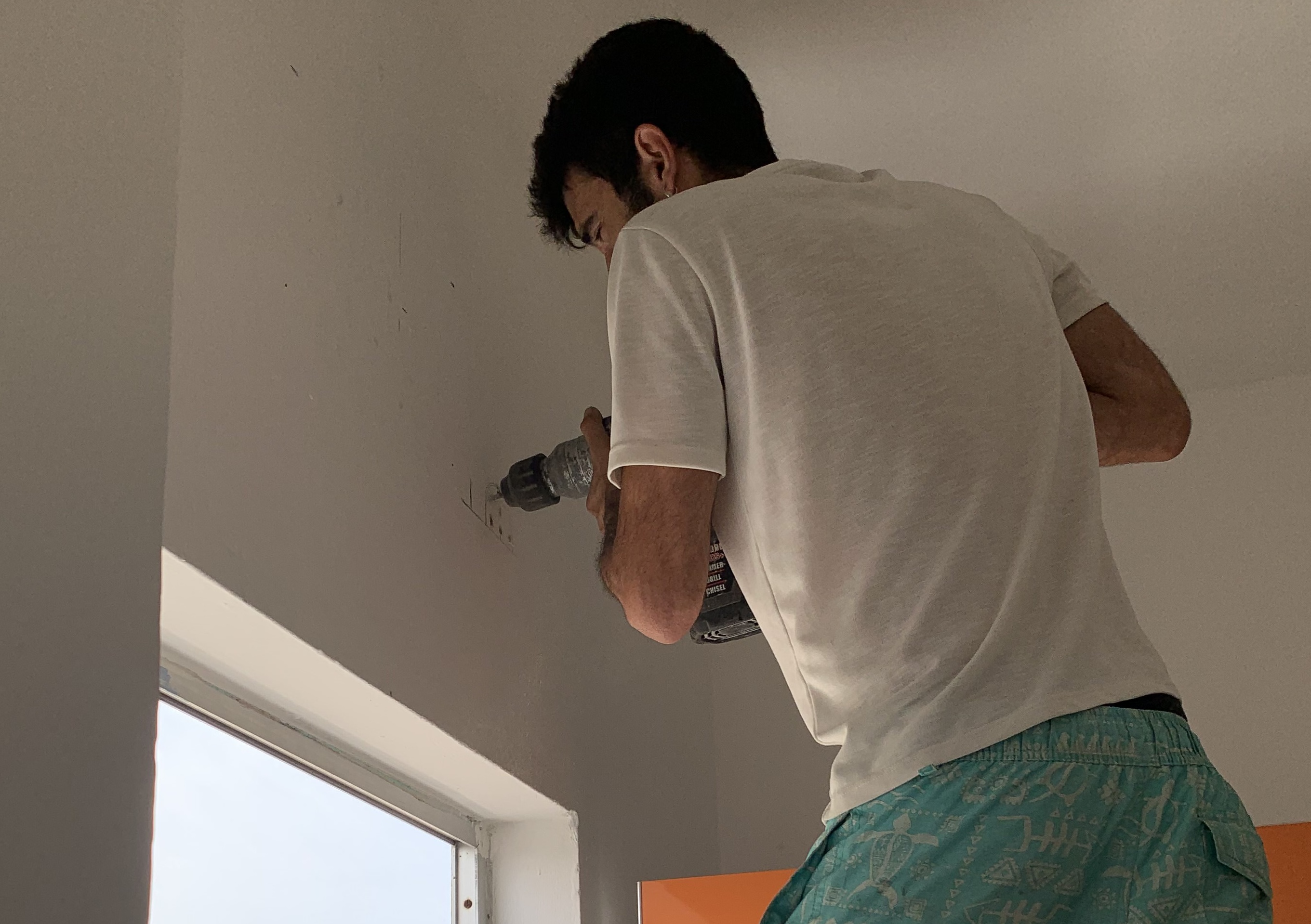 Technician servicing a wall-mounted air conditioning unit